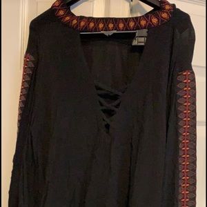 Long sleeve black shirt with criss-cross front.